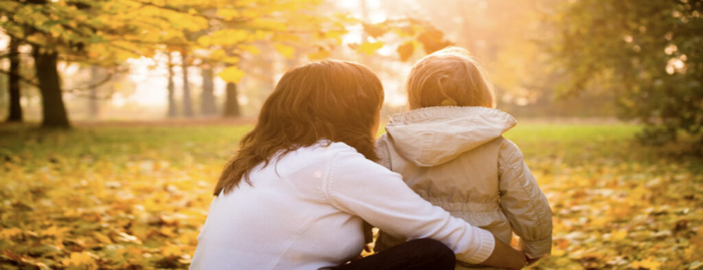 Woman and child facing forward in autumn setting, representing family law